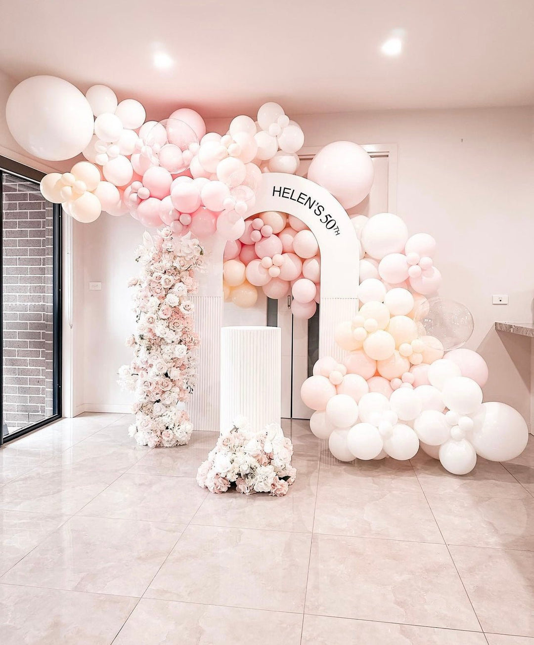 Pink and white balloon arch with flowers for 50th birthday from Parte Haus party supply store in Bethesda MD