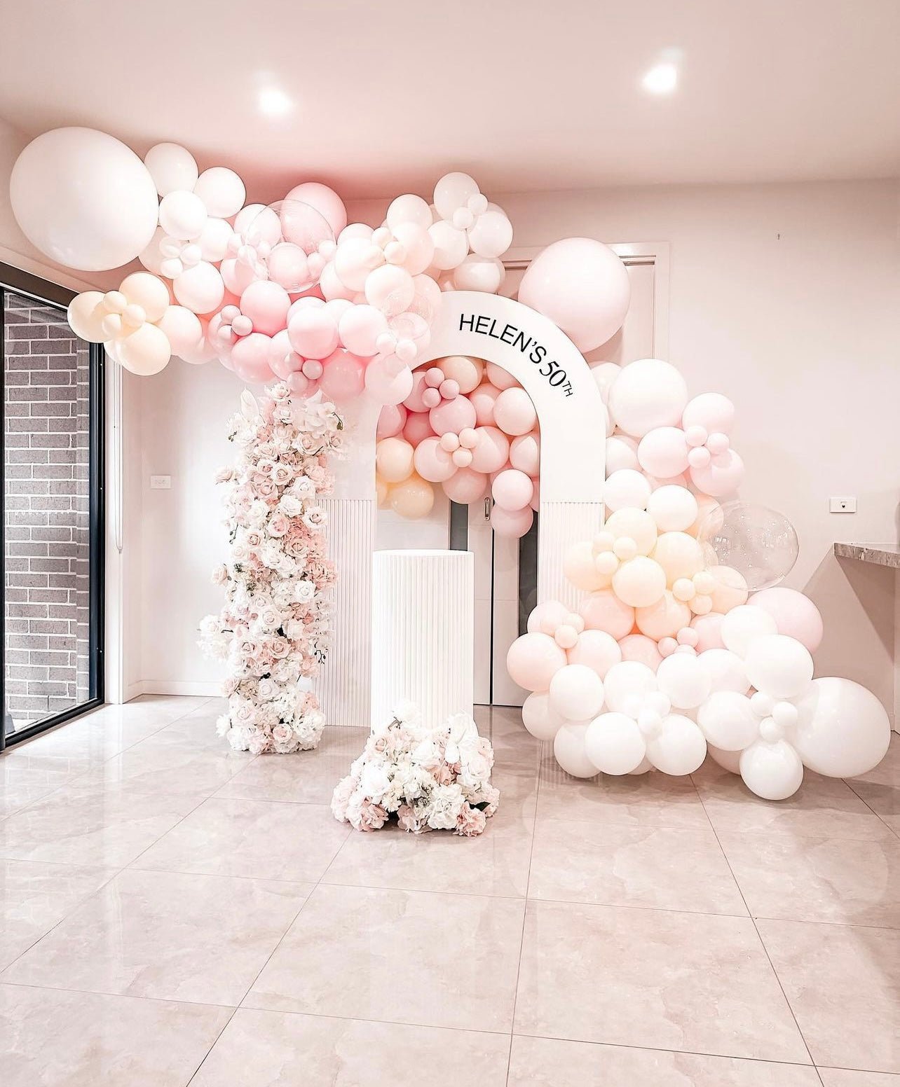 Pink and white balloon arch with flowers for 50th birthday from Parte Haus party supply store in Bethesda MD