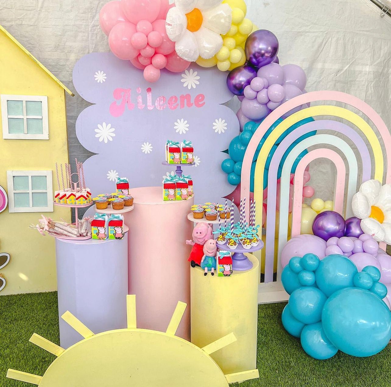 Pastel rainbow birthday backdrop with Peppa Pig decorations for kids from Parte Haus party supply store in Bethesda MD.