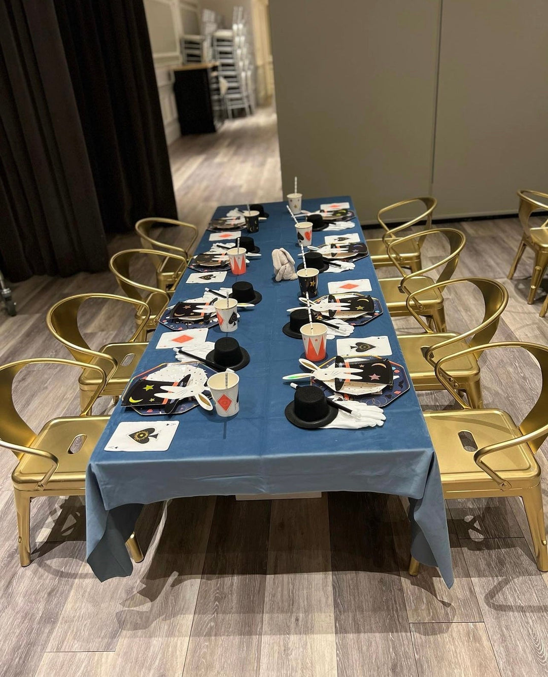 Blue magic themed kids table with gold chairs magician hats and gloves birthday from Parte Haus party supply store in Bethesda Maryland