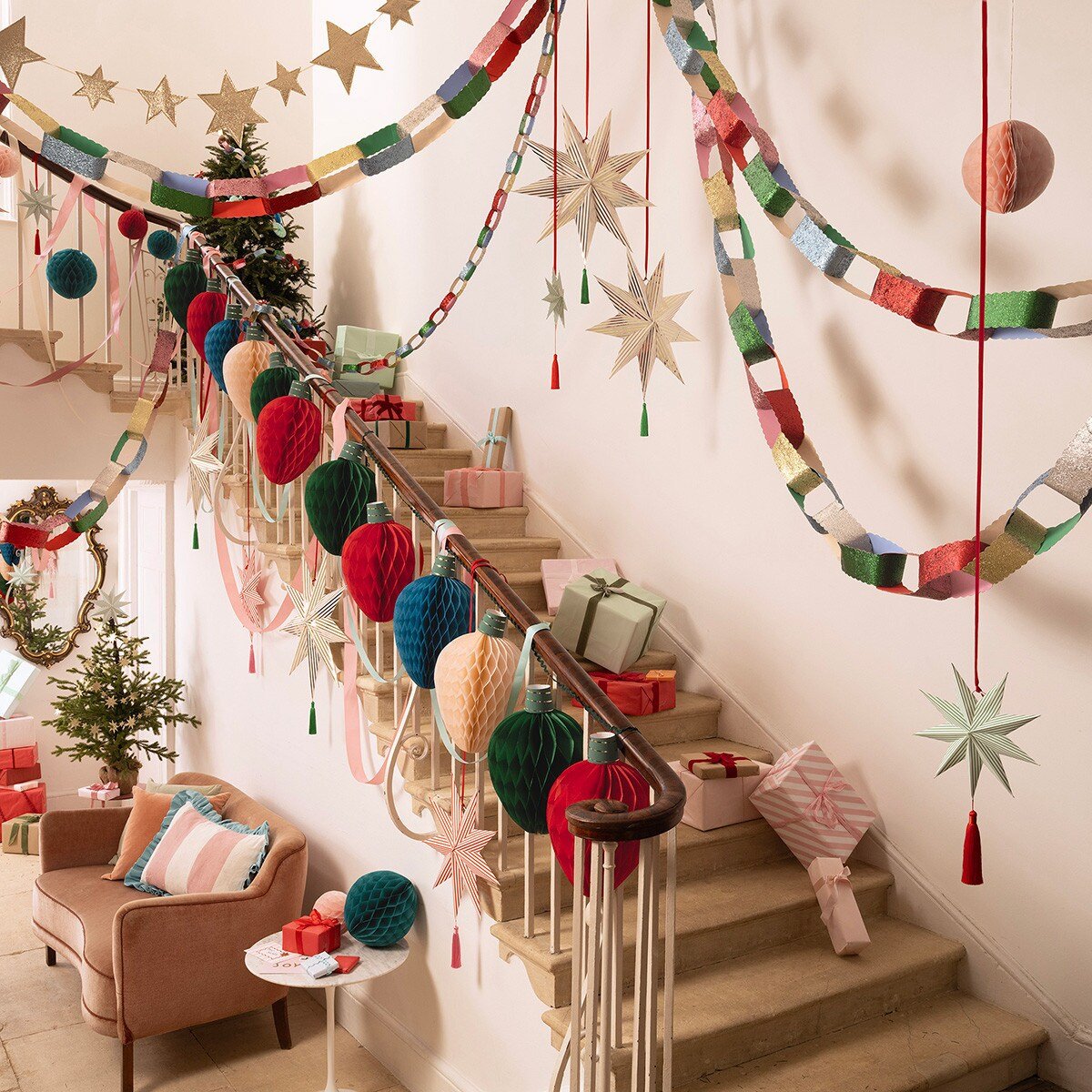 Multicolor Christmas garlands and ornaments decorate a staircase holiday decor from Parte Haus party supply store in Bethesda MD.