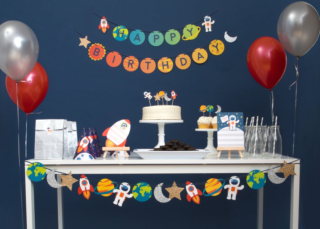 Colorful space birthday table decorations with banners balloons and cake from Parte Haus party supply store in Bethesda MD