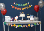 Colorful space birthday table decorations with banners balloons and cake from Parte Haus party supply store in Bethesda MD