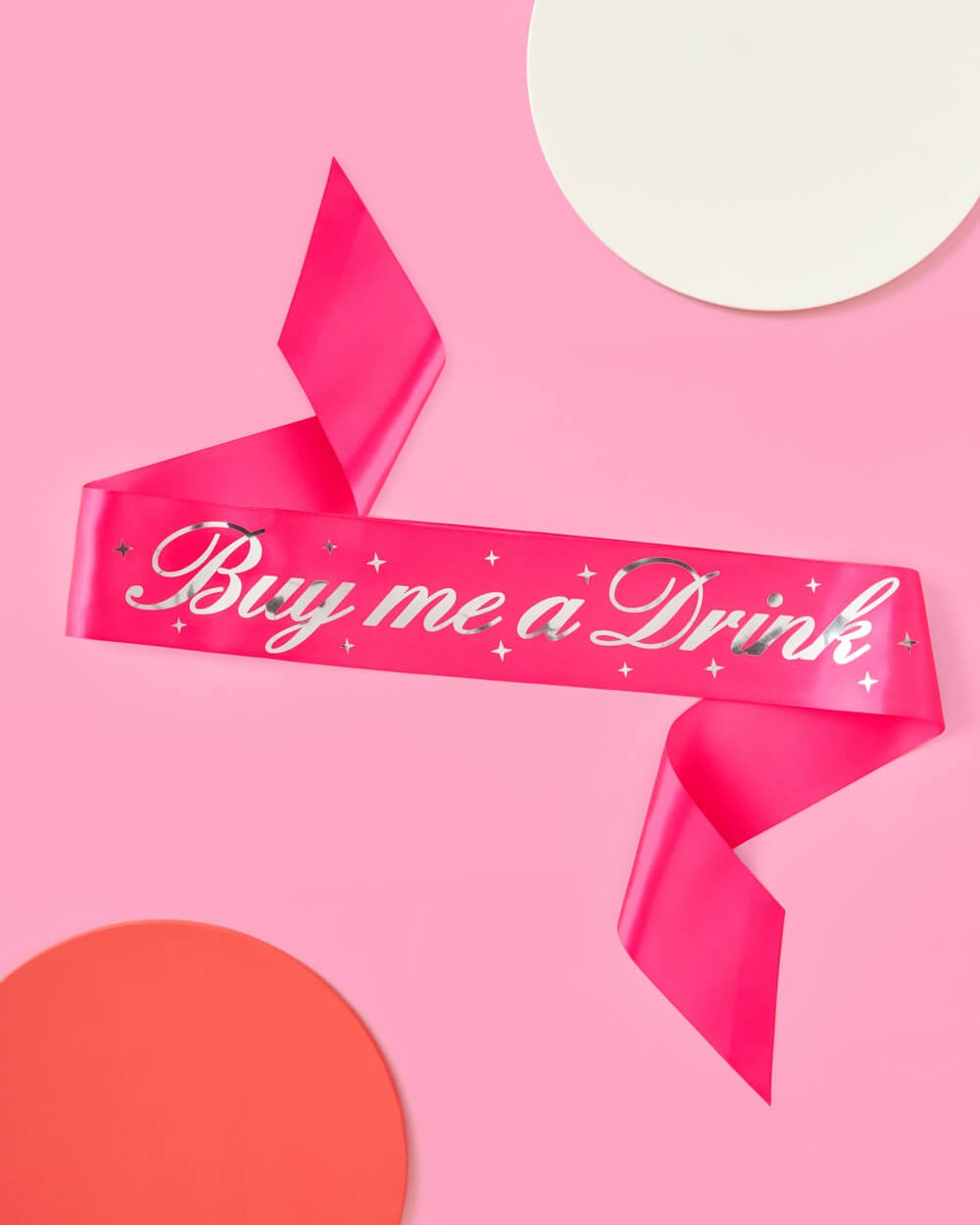 Hot pink Buy Me a Drink sash with silver lettering for bachelorette party from Parte Haus party supply store in Bethesda MD