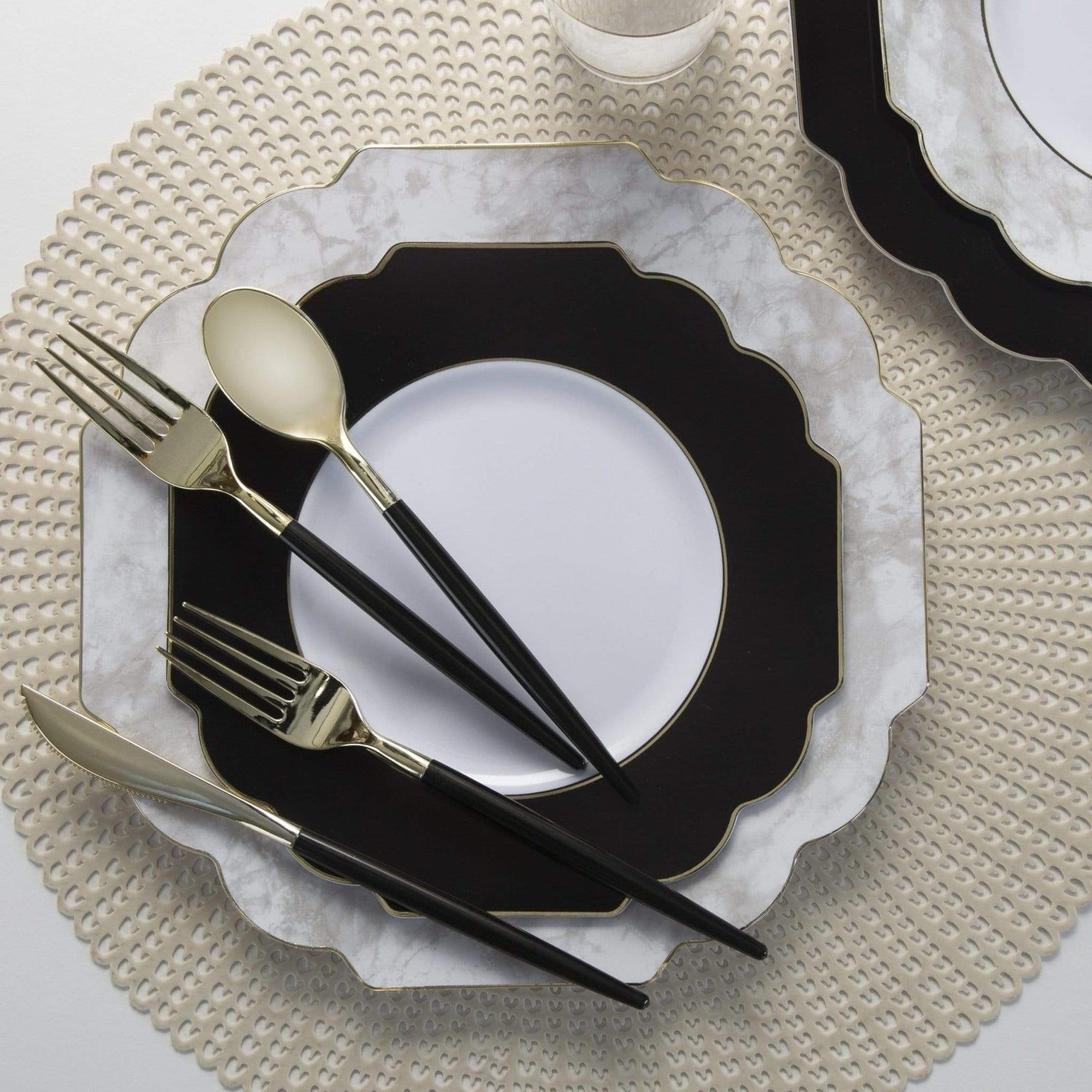 Black and gold cutlery set with marble plates elegant table setting for celebration from Parte Haus party supply store in Bethesda Maryland