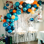 Blue and orange space theme balloon arch with astronaut and rocket decorations birthday from Parte Haus party supply store in Bethesda MD
