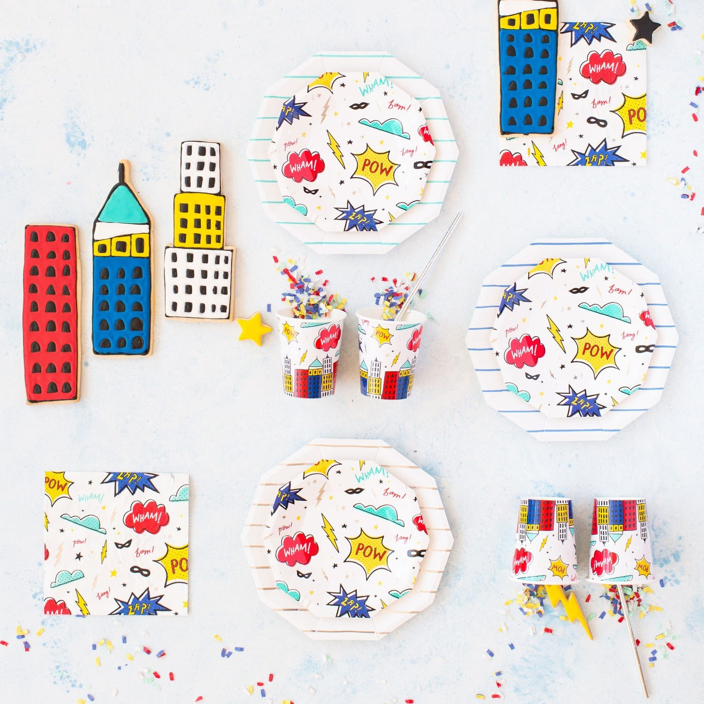 Colorful superhero comic themed plates cups and cookies for kids birthday from Parte Haus party supply store in Bethesda MD