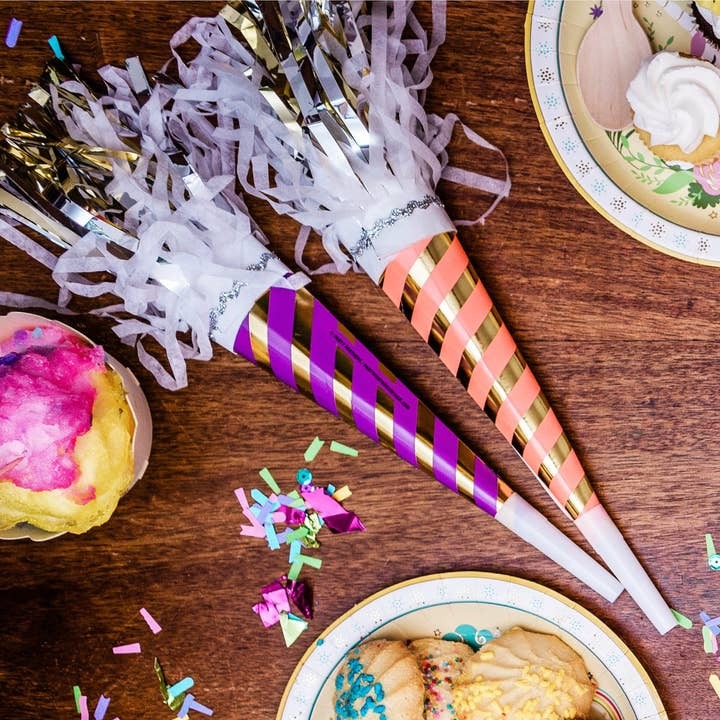 Purple and pink striped party horn blowers with gold accents for birthday celebration from Parte Haus party supply store in Bethesda MD