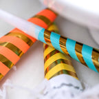 Yellow blue orange striped party horns for birthday celebration from Parte Haus party supply store in Bethesda MD