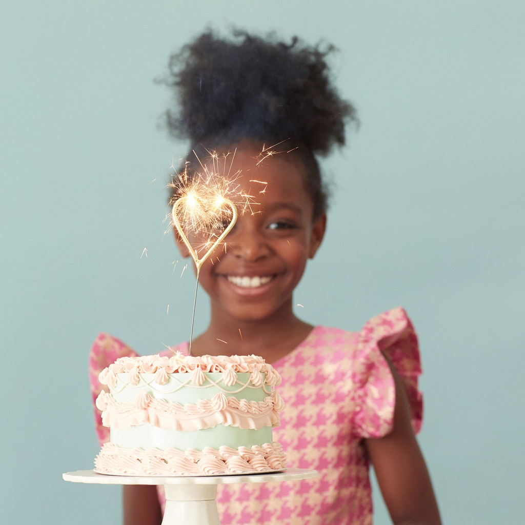 Pink and white heart sparkler on a cake for birthday celebration from Parte Haus party supply store in Bethesda MD