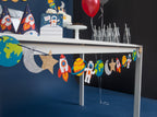 Colorful space theme paper garland with rockets planets astronauts birthday from Parte Haus party supply store in Bethesda MD