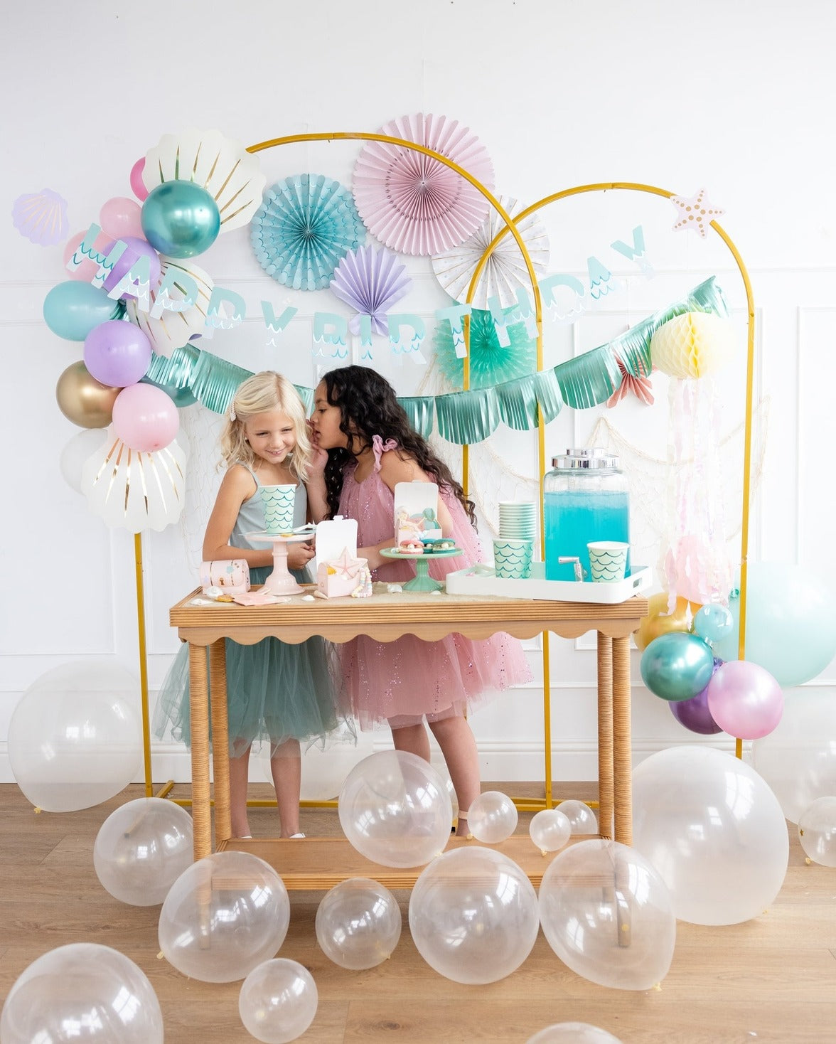 Pastel mermaid birthday backdrop with balloons and decorations from Parte Haus party supply store in Bethesda Maryland