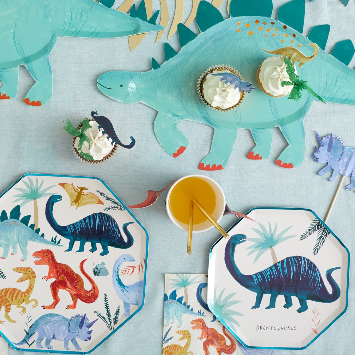 Blue dinosaur plates and decorations for kids birthday from Parte Haus party supply store in Bethesda Maryland