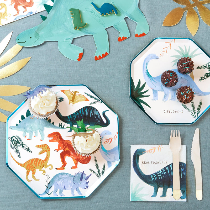 Colorful dinosaur birthday plates and napkins on table from Parte Haus party supply store in Bethesda MD