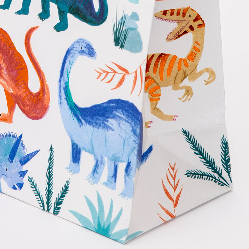 Colorful dinosaur print gift bag for kids birthday from Parte Haus party supply store in Bethesda, Maryland