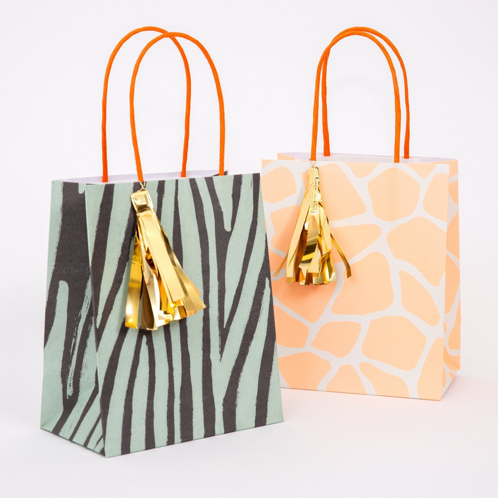 Green zebra and peach giraffe gift bags with gold tassels safari birthday from Parte Haus party supply store in Bethesda MD.