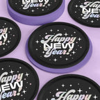 Black and purple Happy New Year plates with disco star design New Year theme from Parte Haus party supply store in Bethesda Maryland