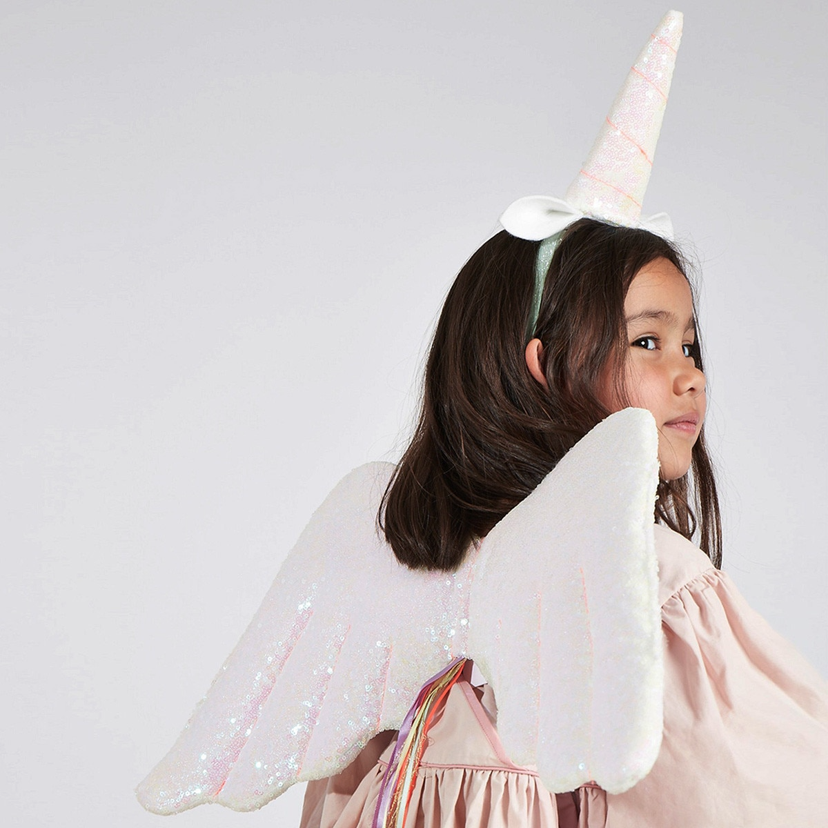 White unicorn dress up costume with glitter wings for kids birthday from Parte Haus party supply store in Bethesda MD