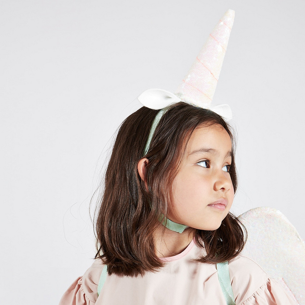 White unicorn horn headband with ears and iridescent wings costume for birthday from Parte Haus party supply store in Bethesda MD