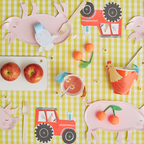 Farm themed pig plates and red tractor decorations kids birthday table from Parte Haus party supply store in Bethesda MD