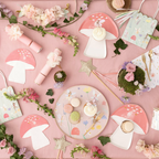 Pink fairy garden birthday tableware with mushroom plates and pastel floral decor from Parte Haus party supply store in Bethesda Maryland