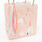 Pink unicorn gift bag with rainbow ribbons fairy tale birthday from Parte Haus party supply store in Bethesda MD.