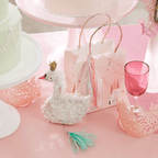 White swan pinata princess theme with pink goodie bag on table from Parte Haus party supply store in Bethesda MD