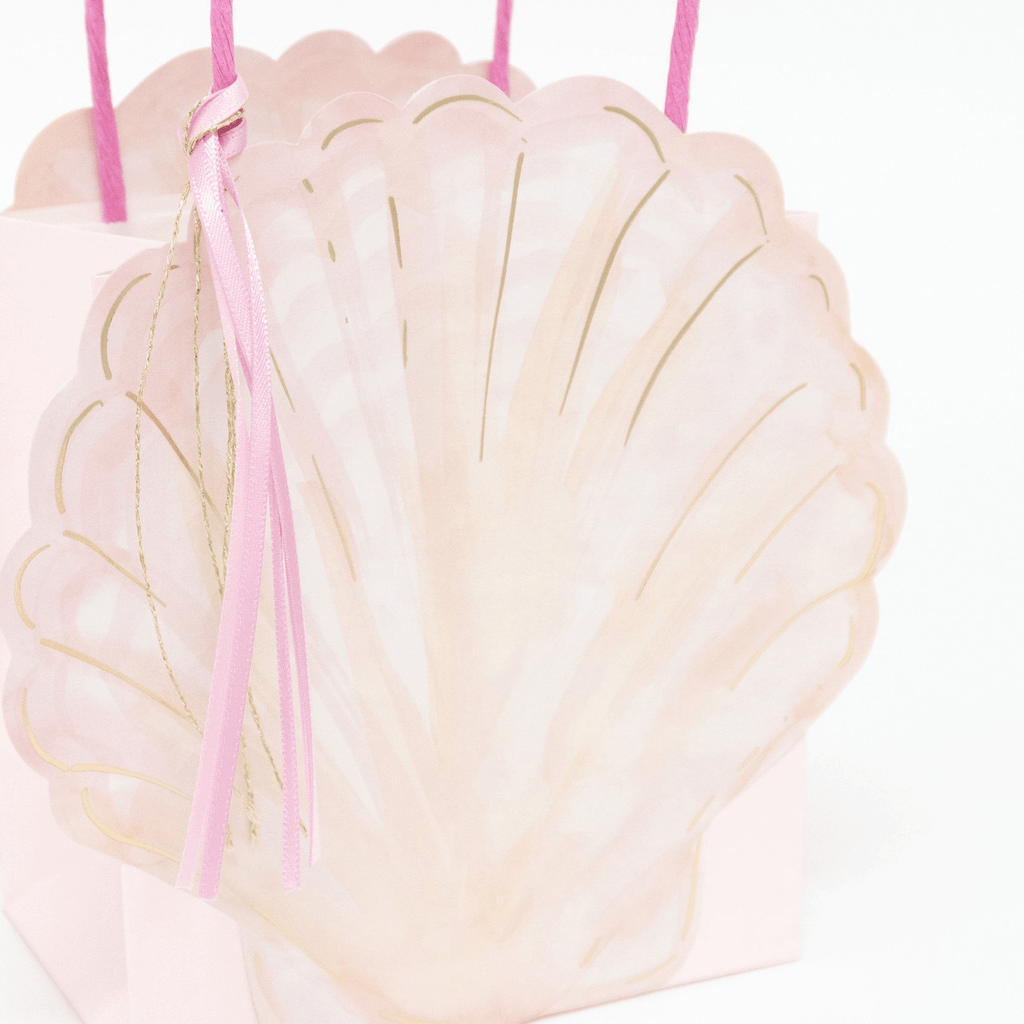 Pink seashell gift bag with gold accents and pink handles mermaid theme from Parte Haus party supply store in Bethesda MD