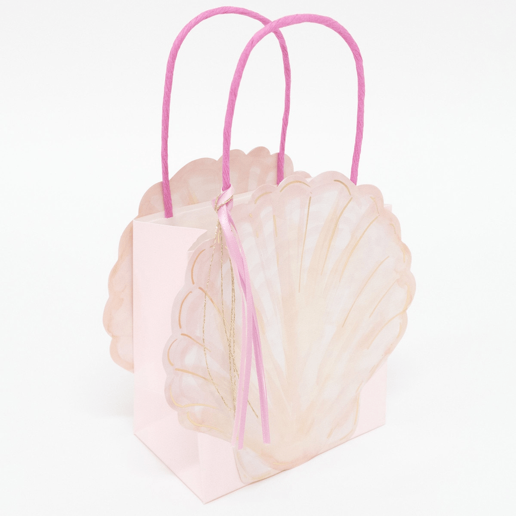 Pink seashell gift bag with gold accents and ribbons for mermaid birthday from Parte Haus party supply store in Bethesda MD