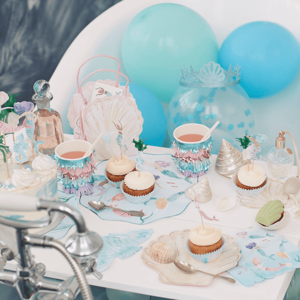 Blue pastel mermaid birthday table decor with cupcakes and seashells from Parte Haus party supply store in Bethesda MD