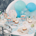 Blue pastel mermaid birthday table decor with cupcakes and seashells from Parte Haus party supply store in Bethesda MD