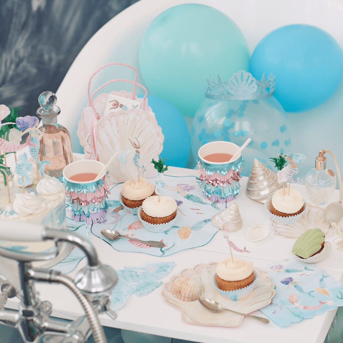 Blue pastel mermaid birthday table decor with cupcakes and seashells from Parte Haus party supply store in Bethesda MD