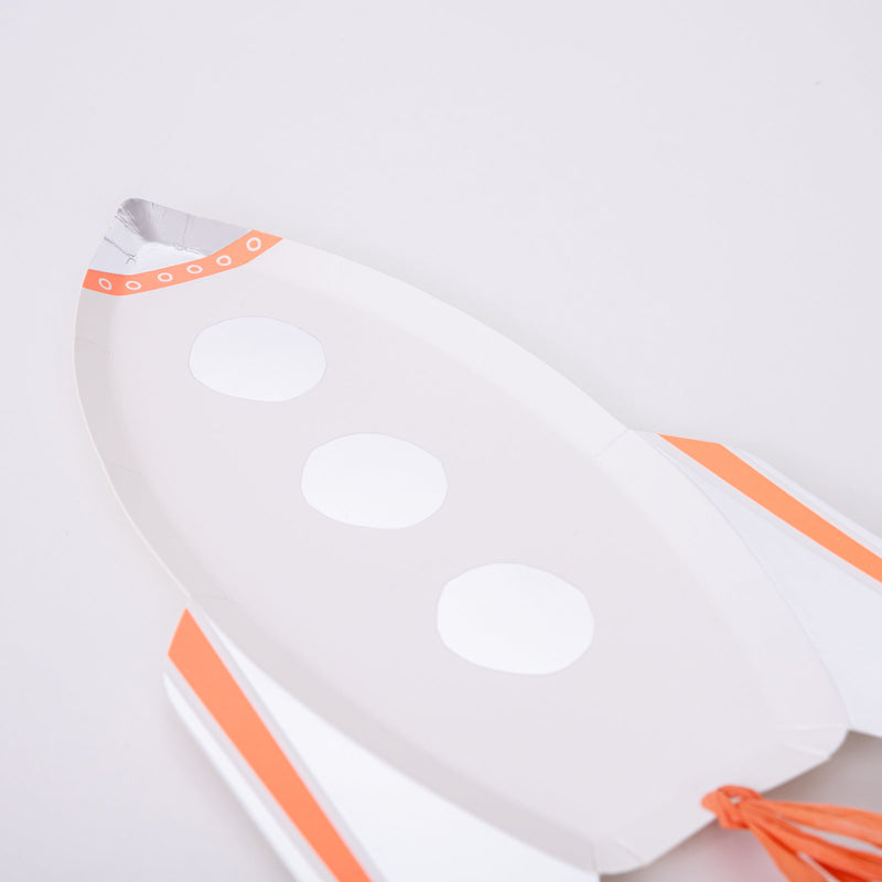 White and orange rocket shaped plate with silver accents space theme from Parte Haus party supply store in Bethesda MD