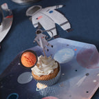 Blue astronaut cupcake topper on galaxy paper plate space theme birthday from Parte Haus party supply store in Bethesda MD.