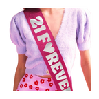 Pink glitter birthday sash with 21 Forever text for birthday party from Parte Haus party supply store in Bethesda MD