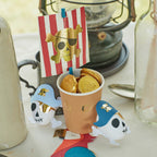 Gold pirate cup with chocolate coins and pirate skull decorations for kids birthday from Parte Haus party supply store in Bethesda Maryland