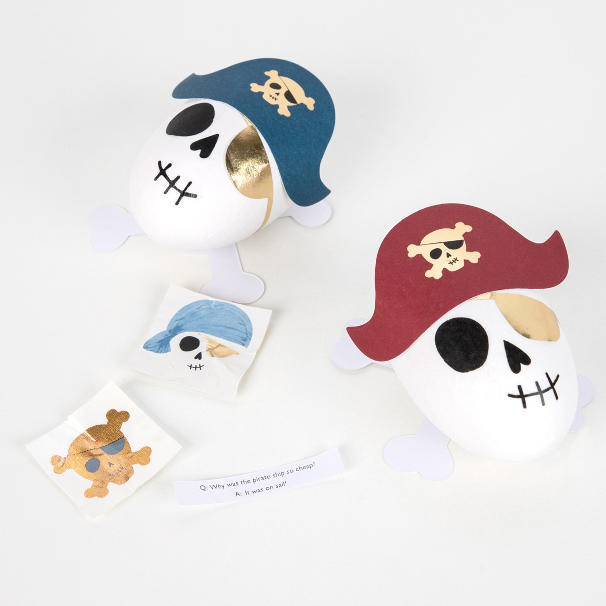 Blue and red pirate skull shaped favor containers with gold accents for kids birthday from Parte Haus party supply store in Bethesda MD