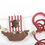 Red pirate garland banner with gold coins and a skull ship for birthday from Parte Haus party supply store in Bethesda MD