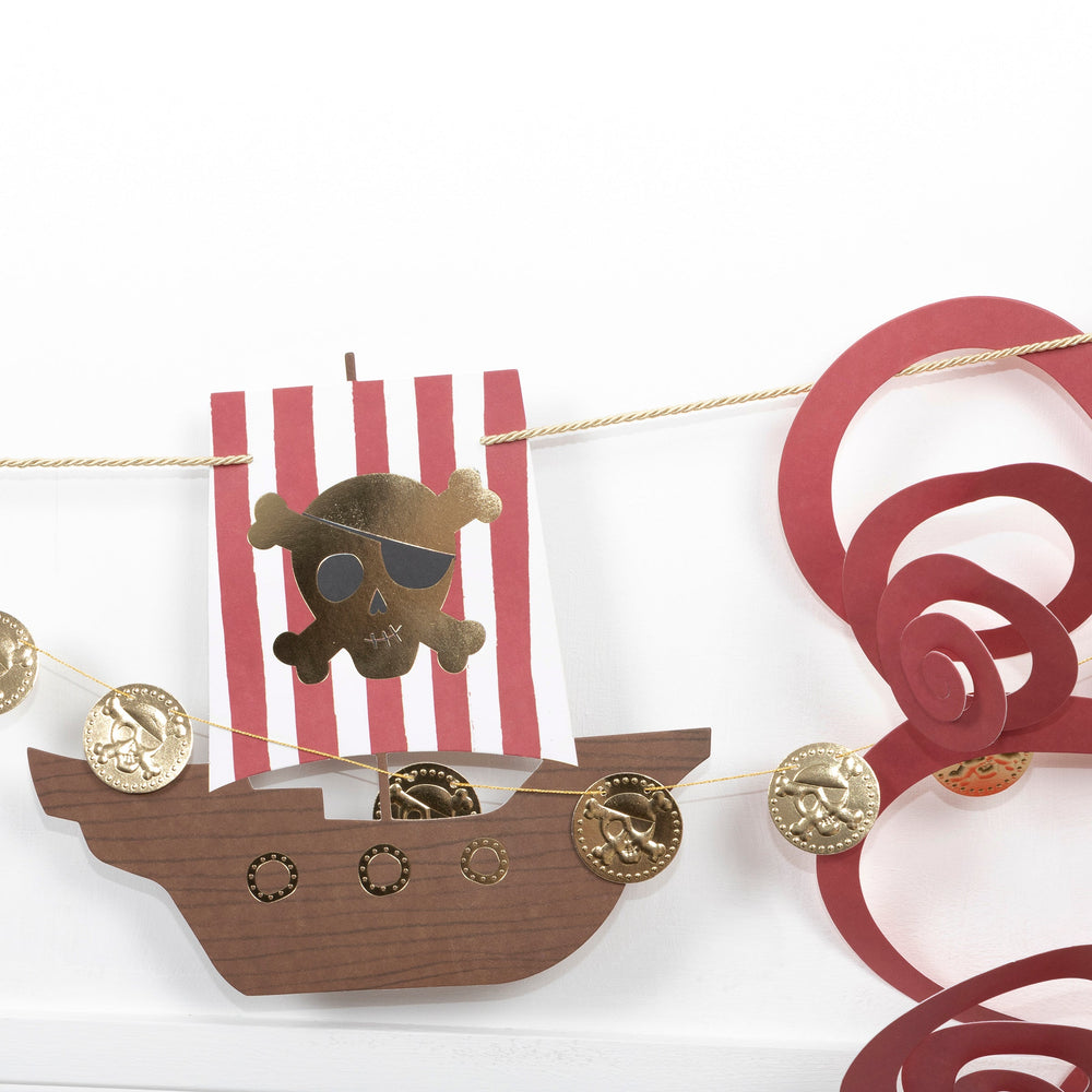 Red pirate garland banner with gold coins and a skull ship for birthday from Parte Haus party supply store in Bethesda MD