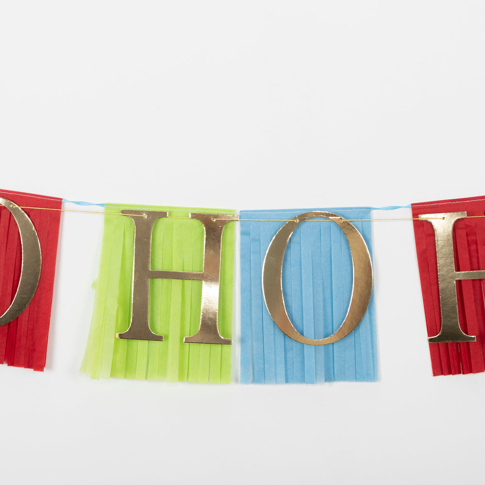 Red green blue HOHO fringe banner garland with gold letters for Christmas from Parte Haus party supply store in Bethesda Maryland