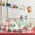 colorful birthday decorations with robot and fairy cake toppers and train banner kids theme from Parte Haus party supply store in Bethesda Maryland
