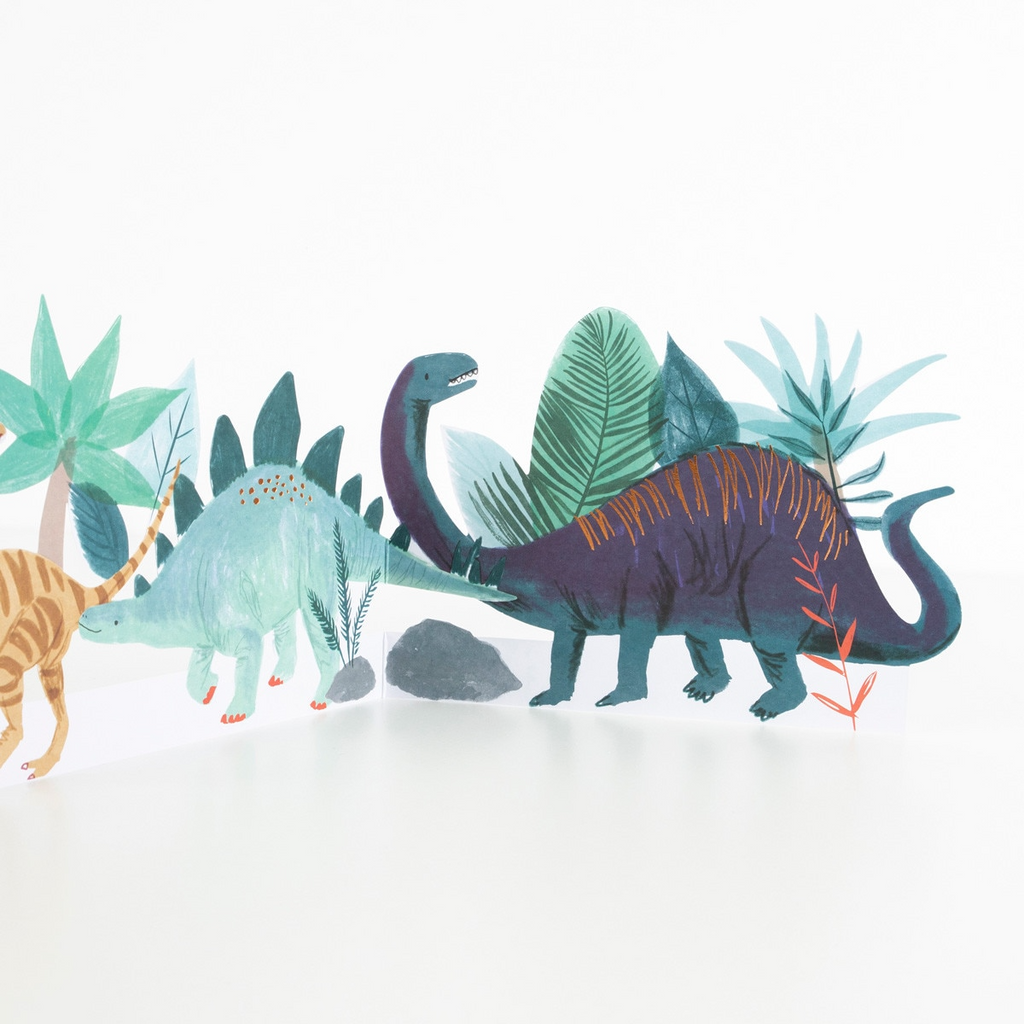 Green and purple dinosaur table centerpiece with jungle leaves dinosaur birthday from Parte Haus party supply store in Bethesda MD