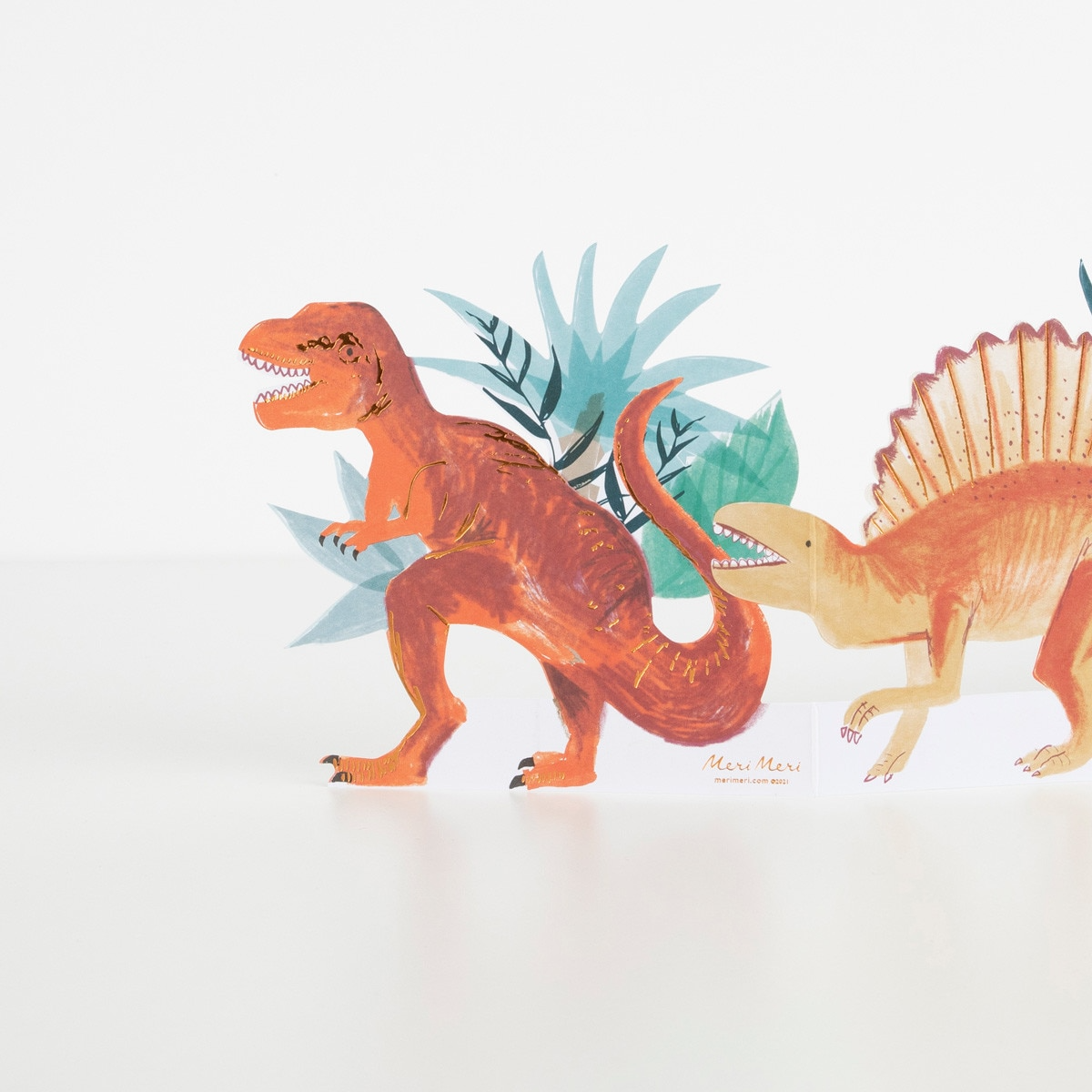 Orange dinosaur garland with green leaves for birthday from Parte Haus party supply store in Bethesda Maryland