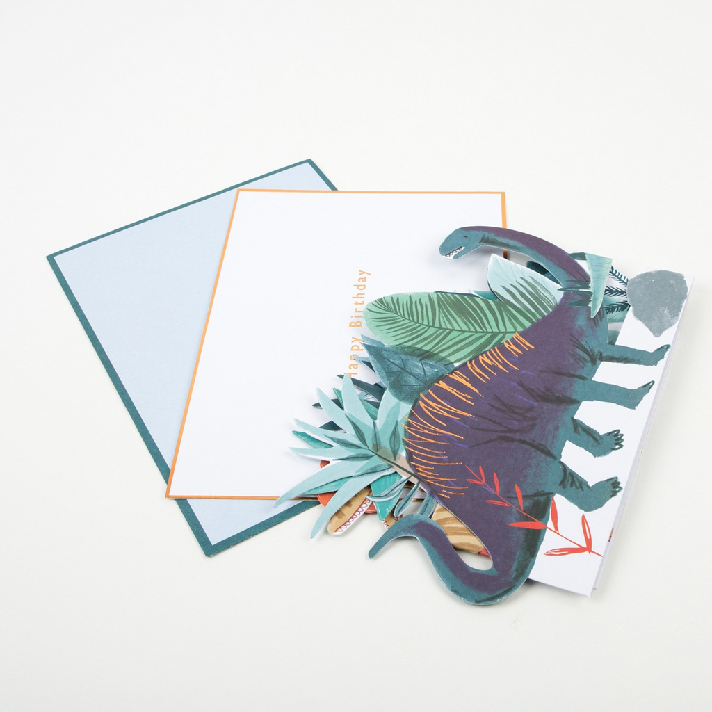 Green and purple dinosaur birthday card with envelope for kids dinosaur theme from Parte Haus party supply store in Bethesda MD