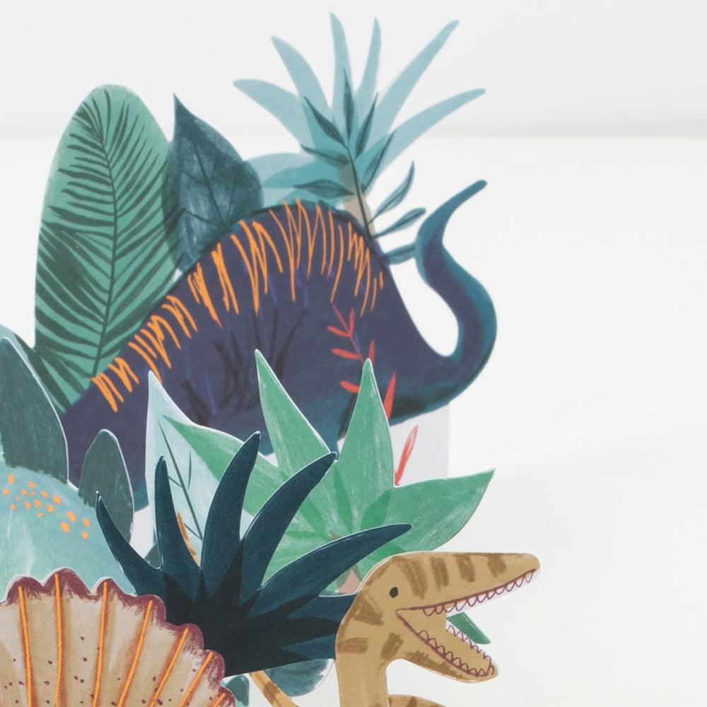 Multicolor dinosaur cake topper with green leaves dinosaur birthday from Parte Haus party supply store in Bethesda MD