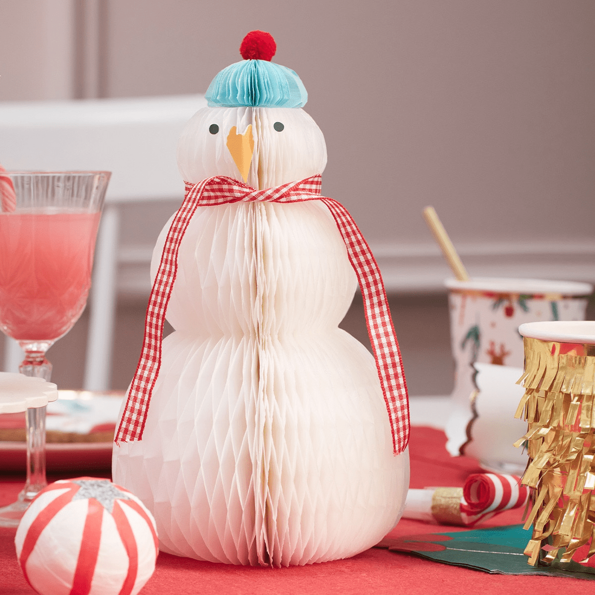 White snowman honeycomb centerpiece with blue hat and red scarf for Christmas from Parte Haus party supply store in Bethesda Maryland