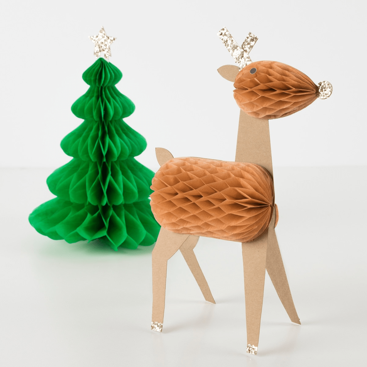 Green and brown honeycomb table decorations with Christmas tree and reindeer for holiday from Parte Haus party supply store in Bethesda MD