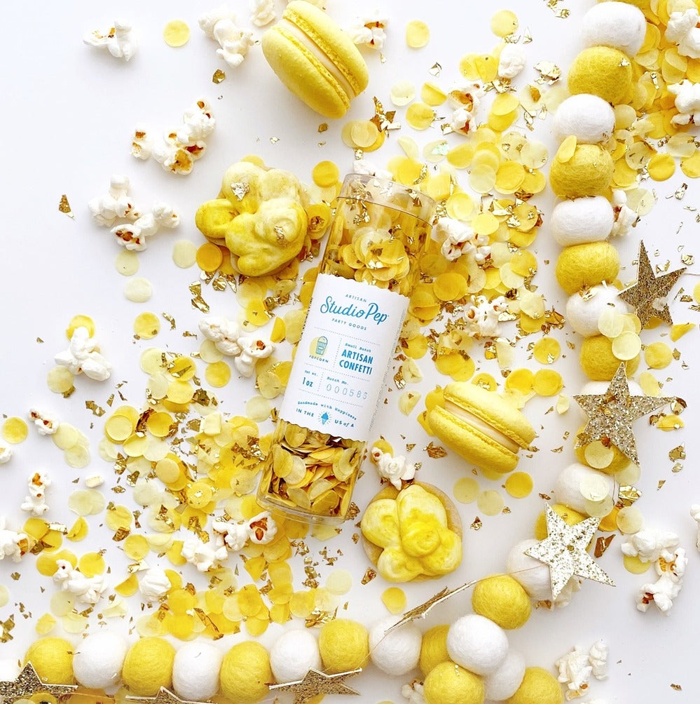 Yellow and white confetti with popcorn macarons and star garland for celebration from Parte Haus party supply store in Bethesda Maryland