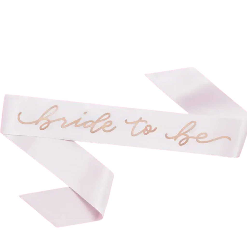 White bride to be sash with gold script for bridal shower from Parte Haus party supply store in Bethesda MD