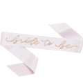 White bride to be sash with gold script for bridal shower from Parte Haus party supply store in Bethesda MD
